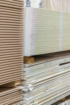 Gypsum plasterboard in the pack. The stack of gypsum board preparing for cons Stock Photos