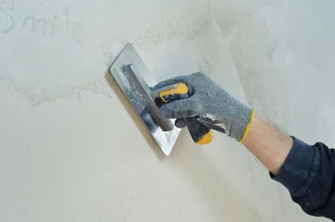Gypsum puttying manually. Stock Photos
