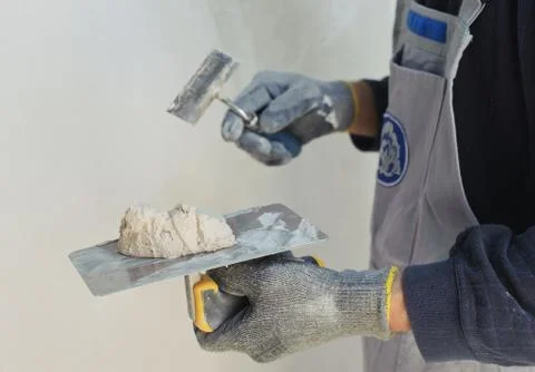 Gypsum puttying manually. Stock Photos