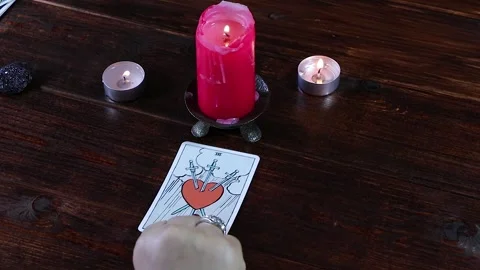A Gypsy fortune-teller puts a Tarot card Stock Footage 130745670