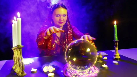 A gypsy in the magic salon is engaged in magic with a crystal ball, from which Stock Footage 108511367