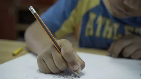 Gypsy, third world school boy drawing and writing on notebook on school class. Stock Footage 73350091