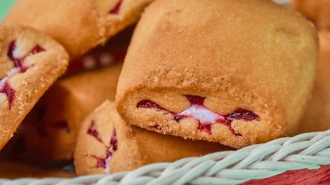 Gyration delicious shortbread with red berry filling in a wicker basket on a  Stock Footage 116709370
