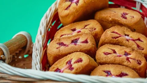 Gyration delicious shortbread with red berry filling in a wicker basket on a  Stock Footage 119008508