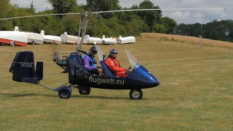 Gyrocopter rolls to the runway Stock Footage