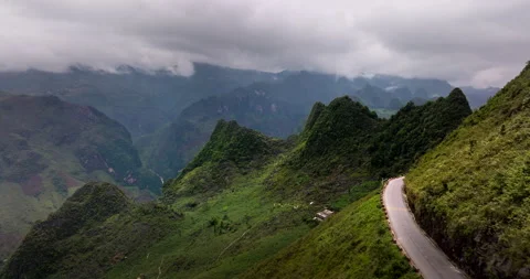 Ha Giang Loop, ribbon of road through emerald mountains so high, aerial Stock Footage 282352691