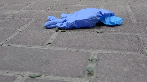 Habitat pollution problem. Used gloves at the parking near supermarket.  動画素材 128603927