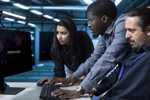 Hacked systems, teamwork and concerned IT team in data center Stock Photos