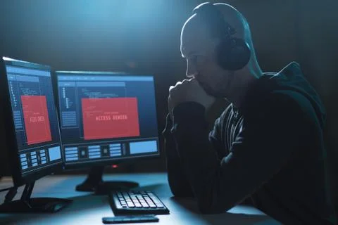Hacker with access denied messages on computers Stock Photos