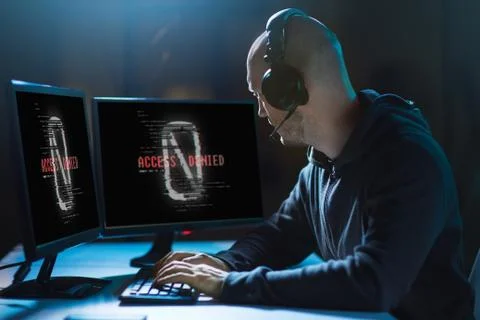 Hacker with access denied messages on computers Stock Photos