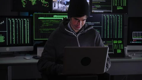 Hacker accessing a company confidential database from his subway hideout. Young Stock Footage 253941357