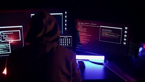Hacker among many monitors in a dark room Stock Footage 194787444