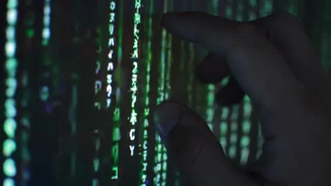 Hacker analyzing matrix code technology on the monitor of computer Stock Footage 201145725