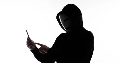 Hacker Anonymous and face mask with smartphone in hand. Stockfoto's