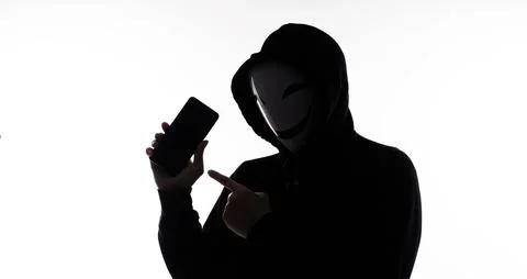 Hacker Anonymous and face mask with smartphone in hand. Stockfoto's