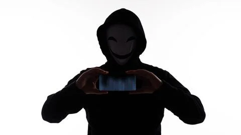Hacker Anonymous and face mask with smartphone in hand. Stock Photos