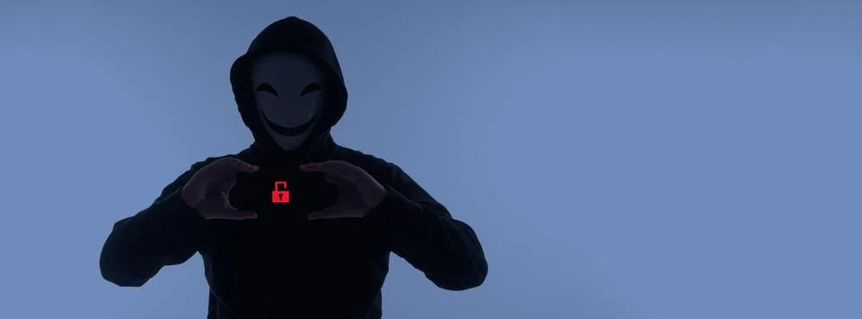 Hacker Anonymous and face mask with smartphone in hand. Stockfoto's