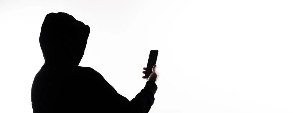 Hacker Anonymous and face mask with smartphone in hand. Stockfoto's