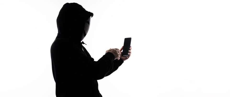 Hacker Anonymous and face mask with smartphone in hand. Stockfoto's