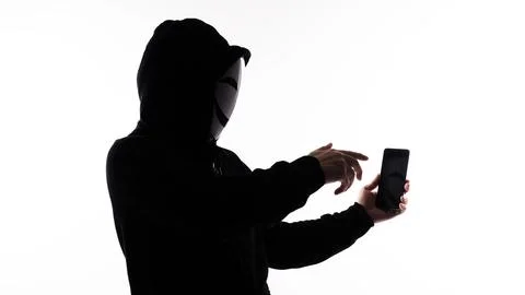 Hacker Anonymous and face mask with smartphone in hand. Stockfoto's