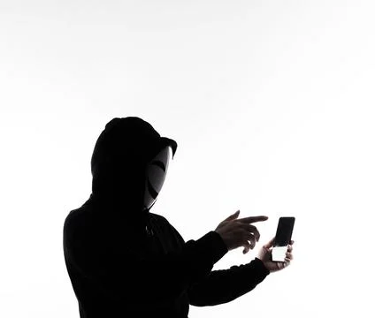 Hacker Anonymous and face mask with smartphone in hand. Stockfoto's