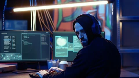 Hacker anxiously looking over shoulder, afraid of being caught and going to jail Stock Footage 319526011