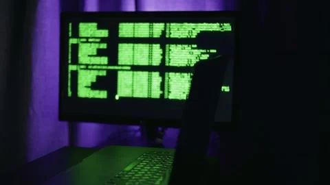 Hacker approaches computer and enters code to conduct cyber attack and hack bank Stock Footage 317940522