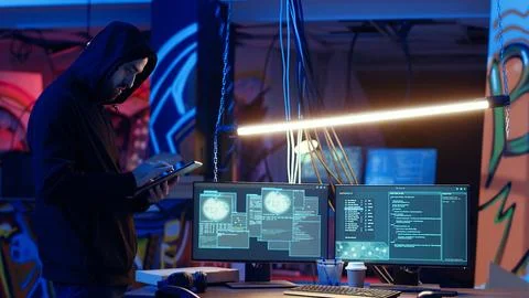 Hacker arriving with tablet in hidden base, deploying viruses Foto stock