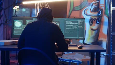 Hacker arriving in underground base, ready to do computer sabotage Stockfoto's