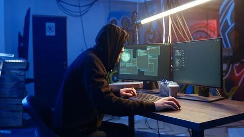 Hacker arriving in underground base, ready to do computer sabotage Stock Photos