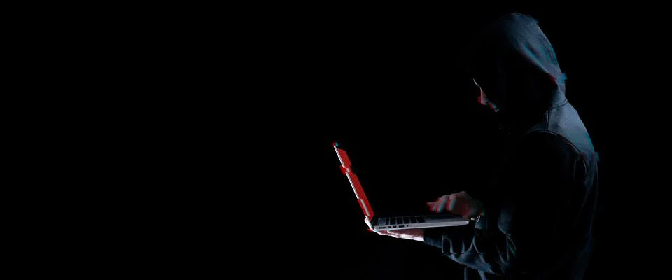 Hacker attack cyber security. Digital laptop in hacker man hand isolated on b 스톡 사진