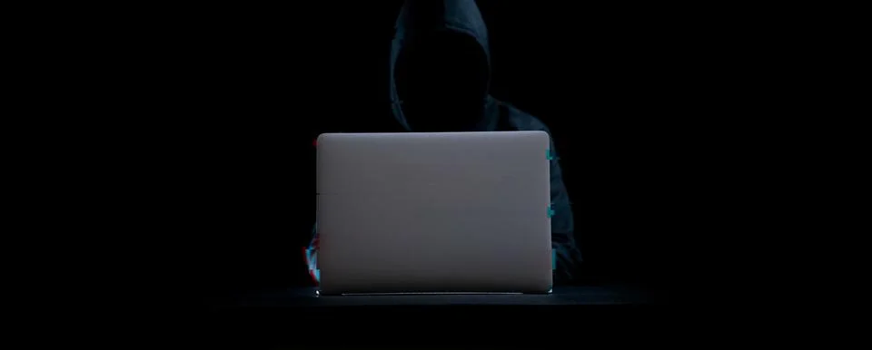 Hacker attack cyber security. Digital laptop in hacker man hand isolated on b Stockfoto's