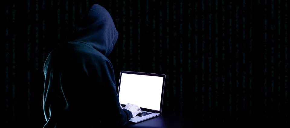Hacker attack cyber security. Digital laptop in hacker man hand isolated on b Stock Photos