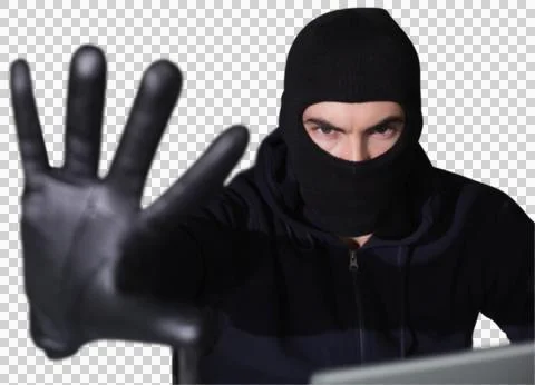 Hacker in balaclava gesturing and looking at camera Stock Photos