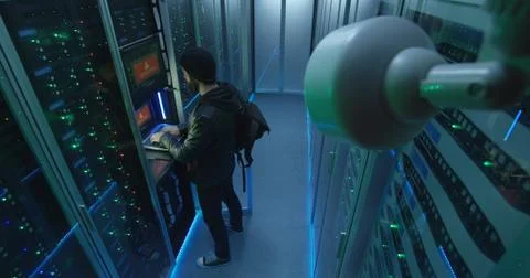 Hacker beginning to hack while checking security camera Stock Photos