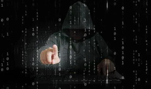 A hacker behind binary code able to break through cyber security Stock Photos