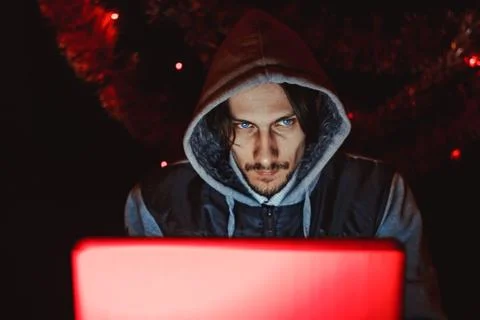 The hacker behind a computer Foto stock