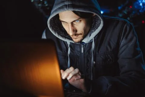 The hacker behind a computer Stock Photos