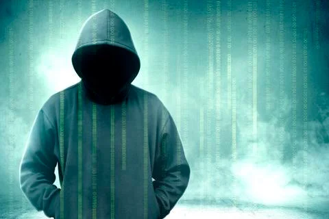 Hacker in black hoodie standing with binary code on virtual screen 库存照片