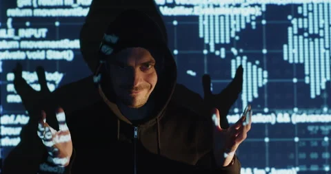 A hacker in a black jacket against the background of infographics Vidéo 196335074