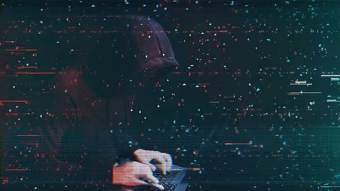Hacker with black mask on face is working at the computer Stock-Footage 111333891