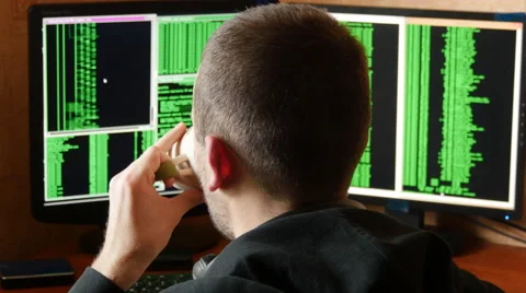 Hacker breaking code and drinking from the cup at desk. Stock Footage 63088039