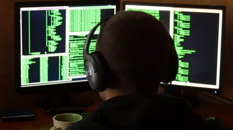 Hacker breaking code and drinking from the cup at desk. hacker with black hood 스톡 동영상 63088572