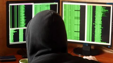 Hacker breaking code and drinking from the cup at your desk 스톡 사진
