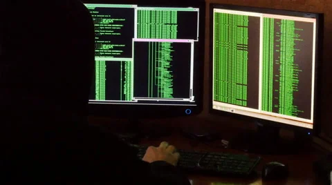 Hacker breaking code. Criminal hacker with black hood penetrating network system Stock Footage 63088632
