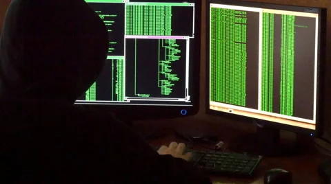 Hacker breaking code. Criminal hacker with black hood penetrating network system Stock Footage 63088783