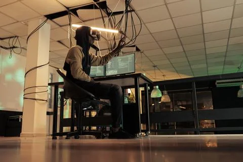 Hacker breaking into computer system in vr, hacking database Stock Photos
