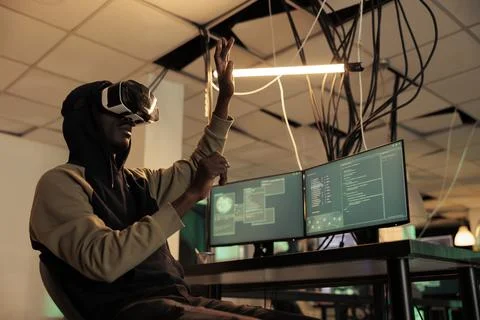 Hacker breaking into databse in vr, spyware coding experience Stock Photos