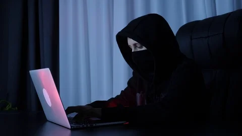 Hacker breaking online security protection on computer. Female in black mask and Video stock 125213389
