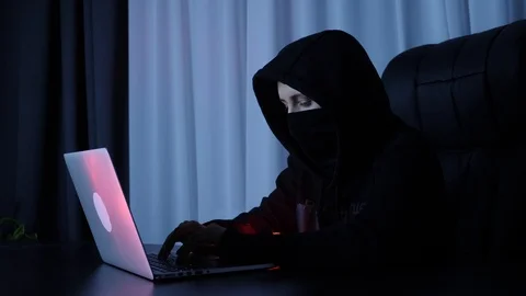 Hacker breaking online security protection on computer. Female in black mask and Vídeos de archivo 125214077